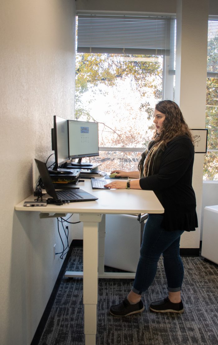 Registered agent standing at computer